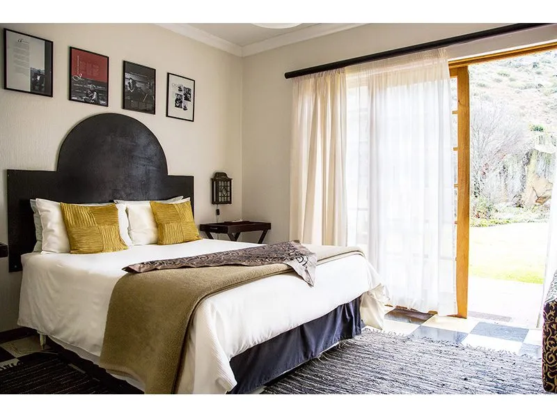 Cozy bedroom with a large bed open sliding door to a garden view