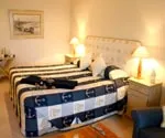 Cozy bedroom with a nauticalthemed bedspread and bedside lamps
