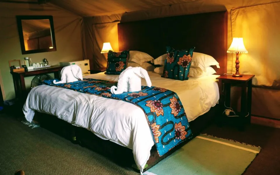 Cozy bedroom with a large bed decorative pillows and bedside lamps