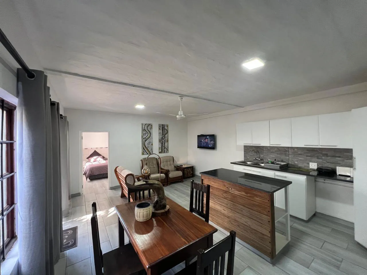 Openplan living area with kitchen dining table and bedroom visible