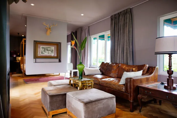 Brown leather sofa in a modern living room with wooden floor and decor