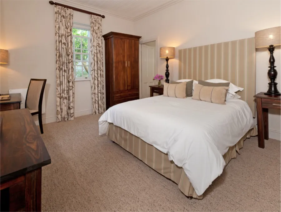 Cozy bedroom with a large bed wooden furniture and floral curtains