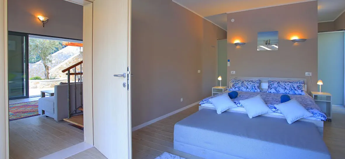 Bedroom with large bed open door to living area and modern decor