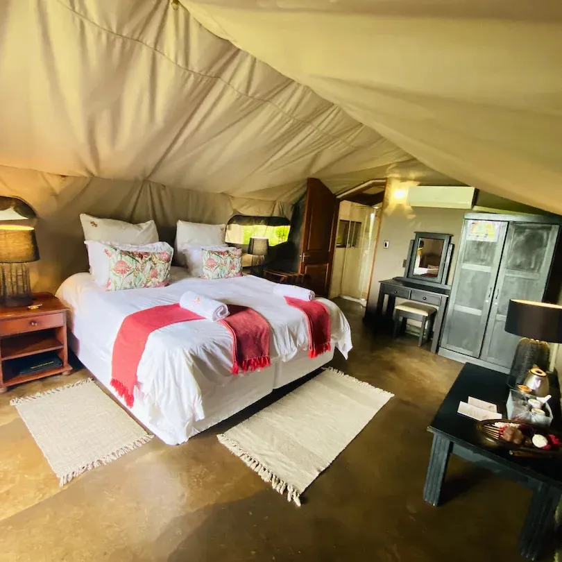Cozy tent bedroom with double bed bedside tables and a dresser