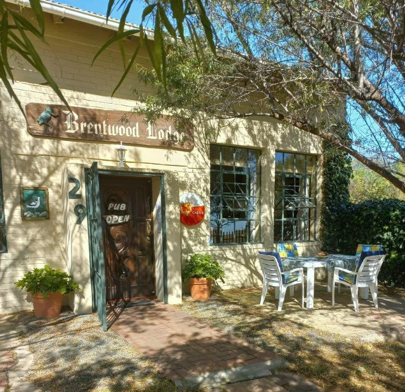 Entrance of Brentwood Lodge with sign door and outdoor seating area