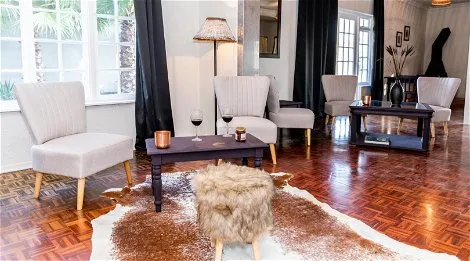 Modern living room with armchairs coffee table and large windows