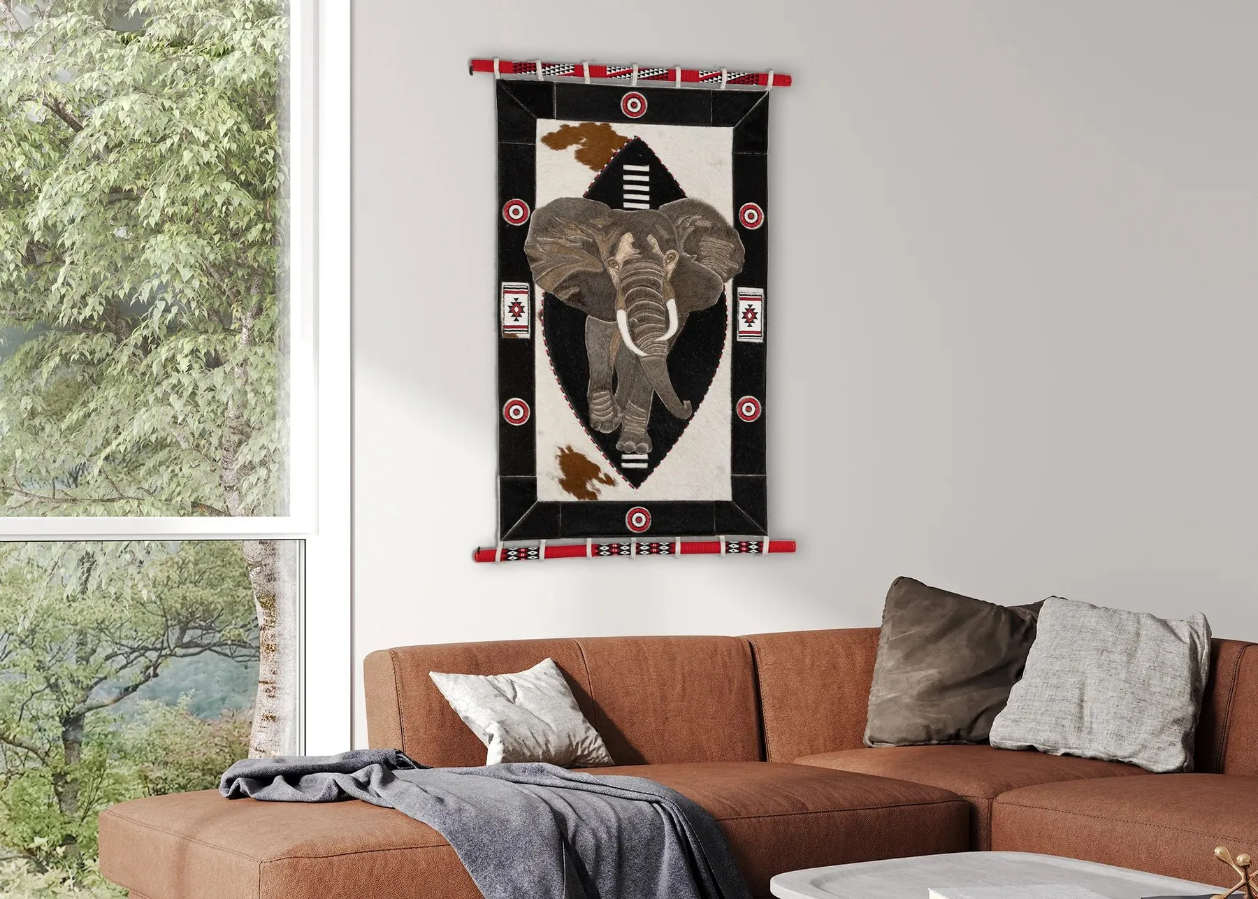 Africanthemed wall art above a brown sofa with a view of trees outside