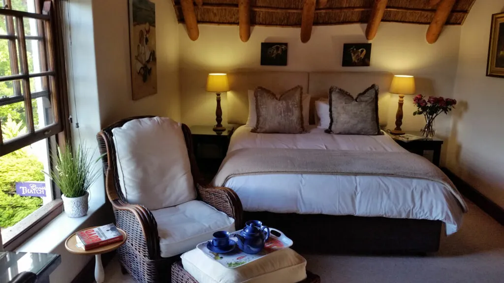 Cozy bedroom with a large bed armchair and bedside lamps