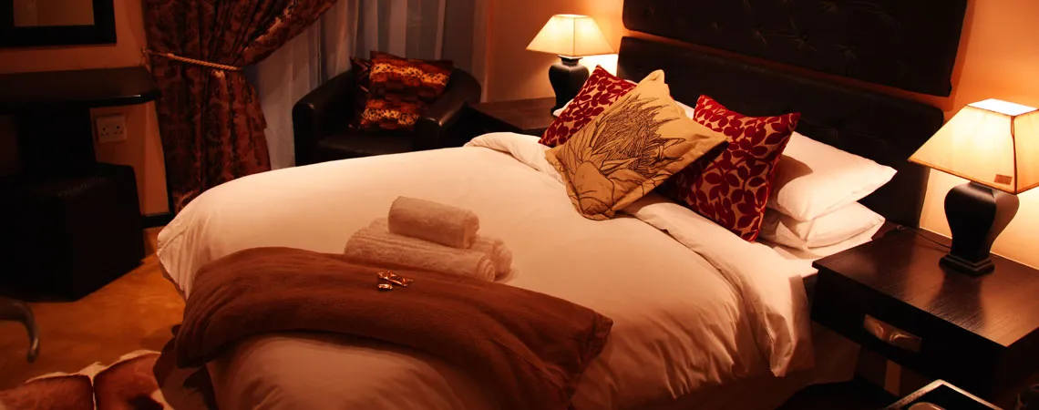 Cozy bedroom with a large bed pillows and bedside lamps