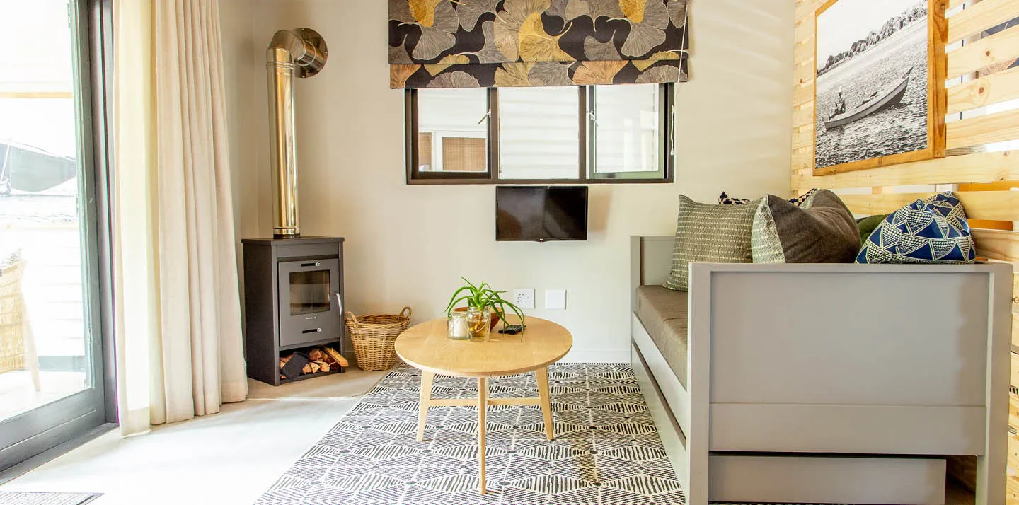 Cozy living room with sofa coffee table and woodburning stove