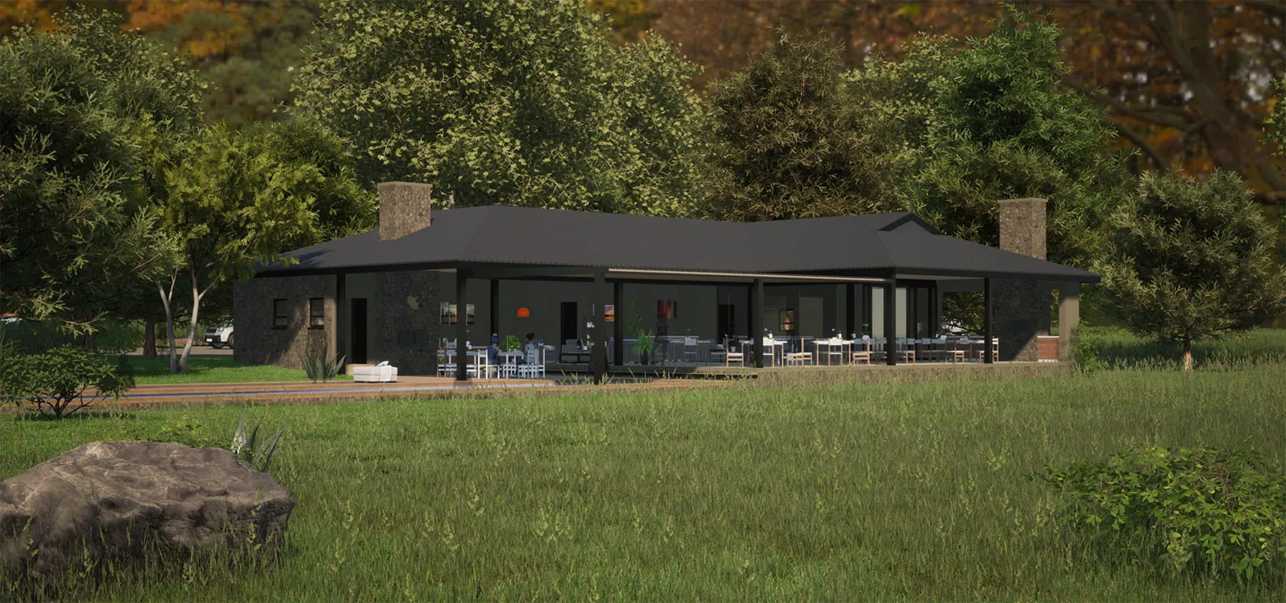 Modern black house with large windows surrounded by trees and grass
