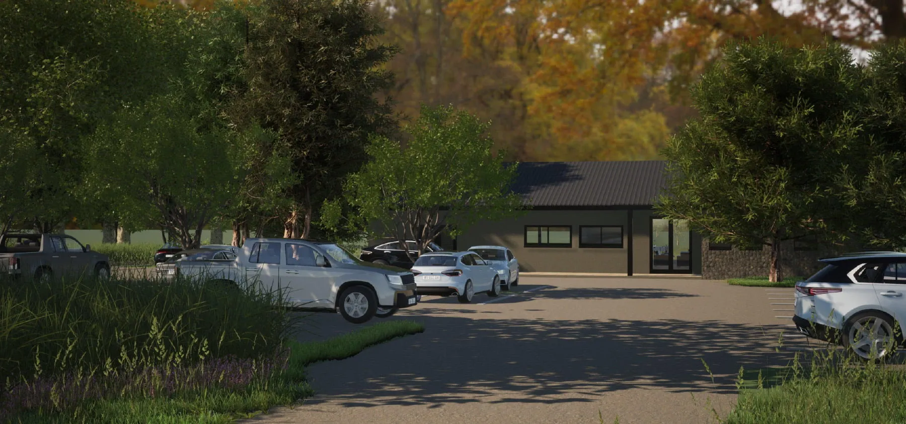 Parking lot with cars and trees in front of a small building