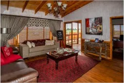 Cozy living room with wooden ceiling sofas and a view of the outdoors