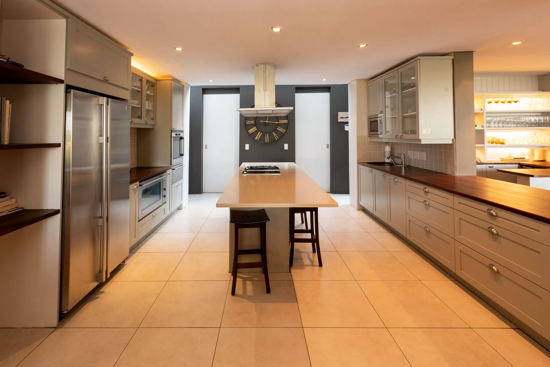 Modern kitchen with central island stainless steel appliances and wooden cabinetry