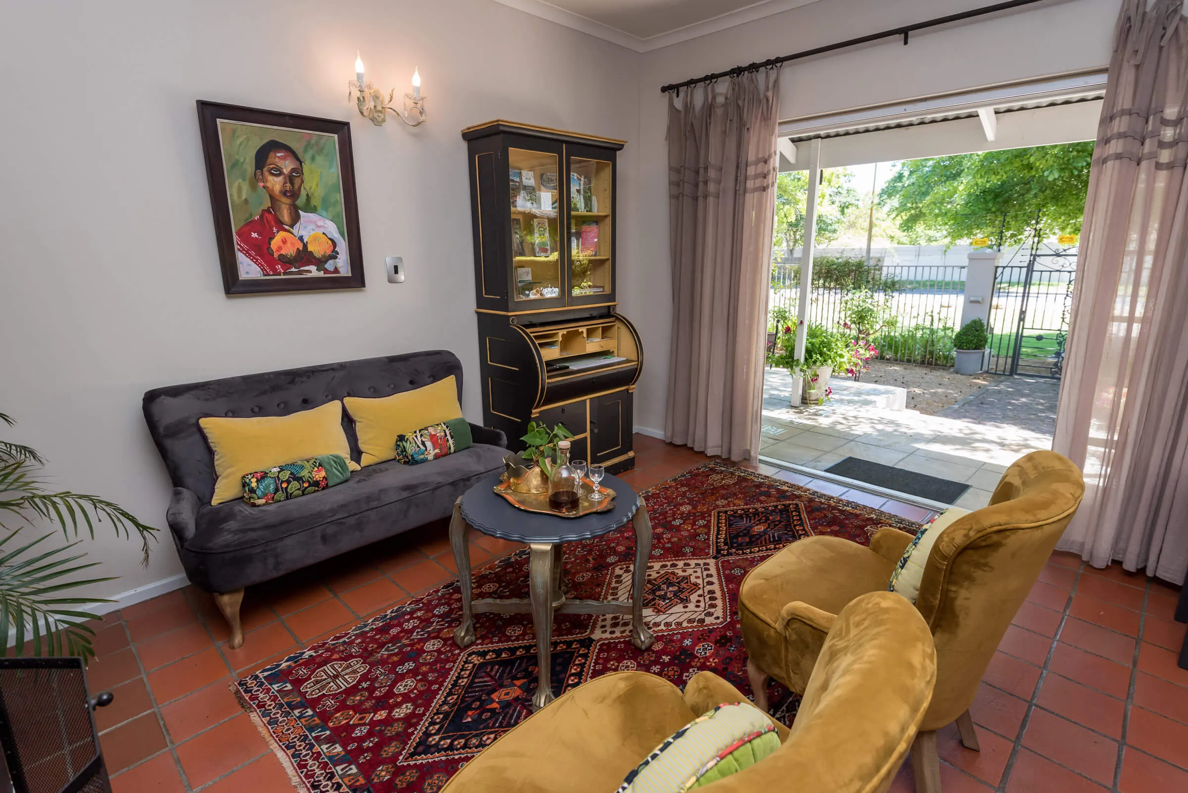 Cozy living room with armchairs sofa and open door to garden