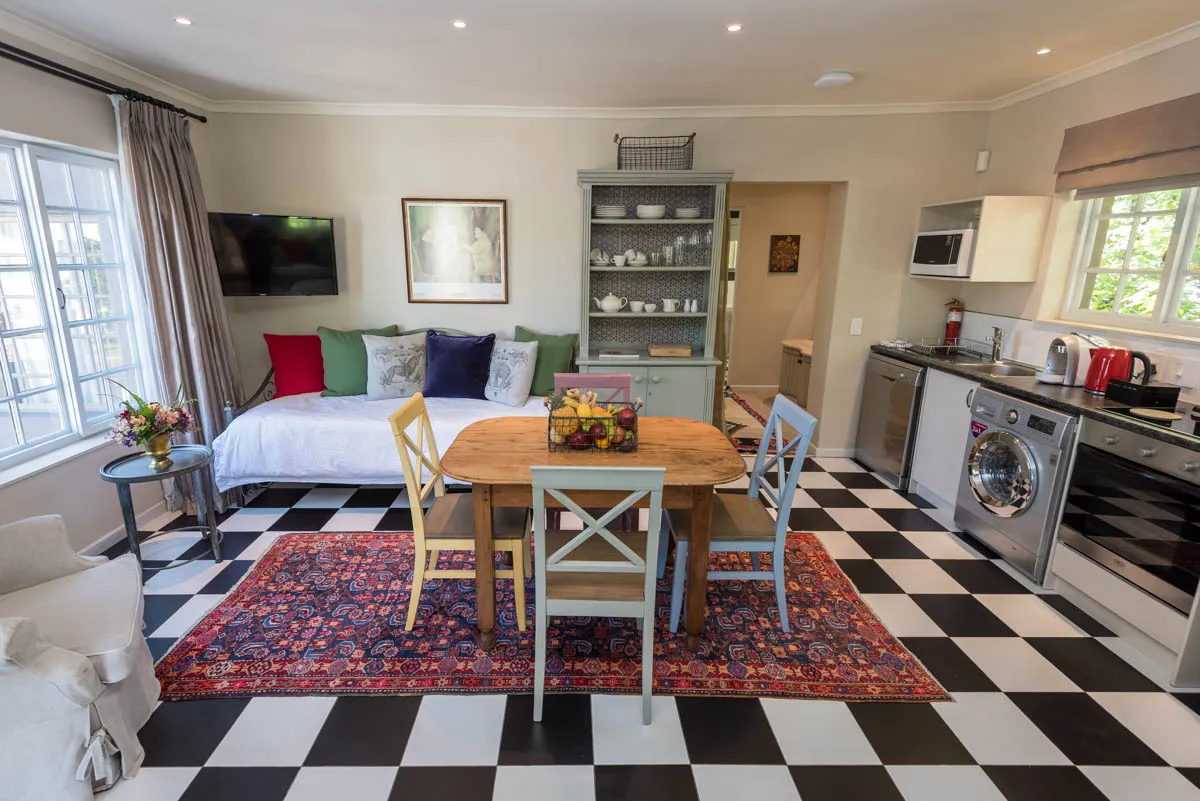 Cozy kitchen with dining table sofa and blackandwhite checkered floor