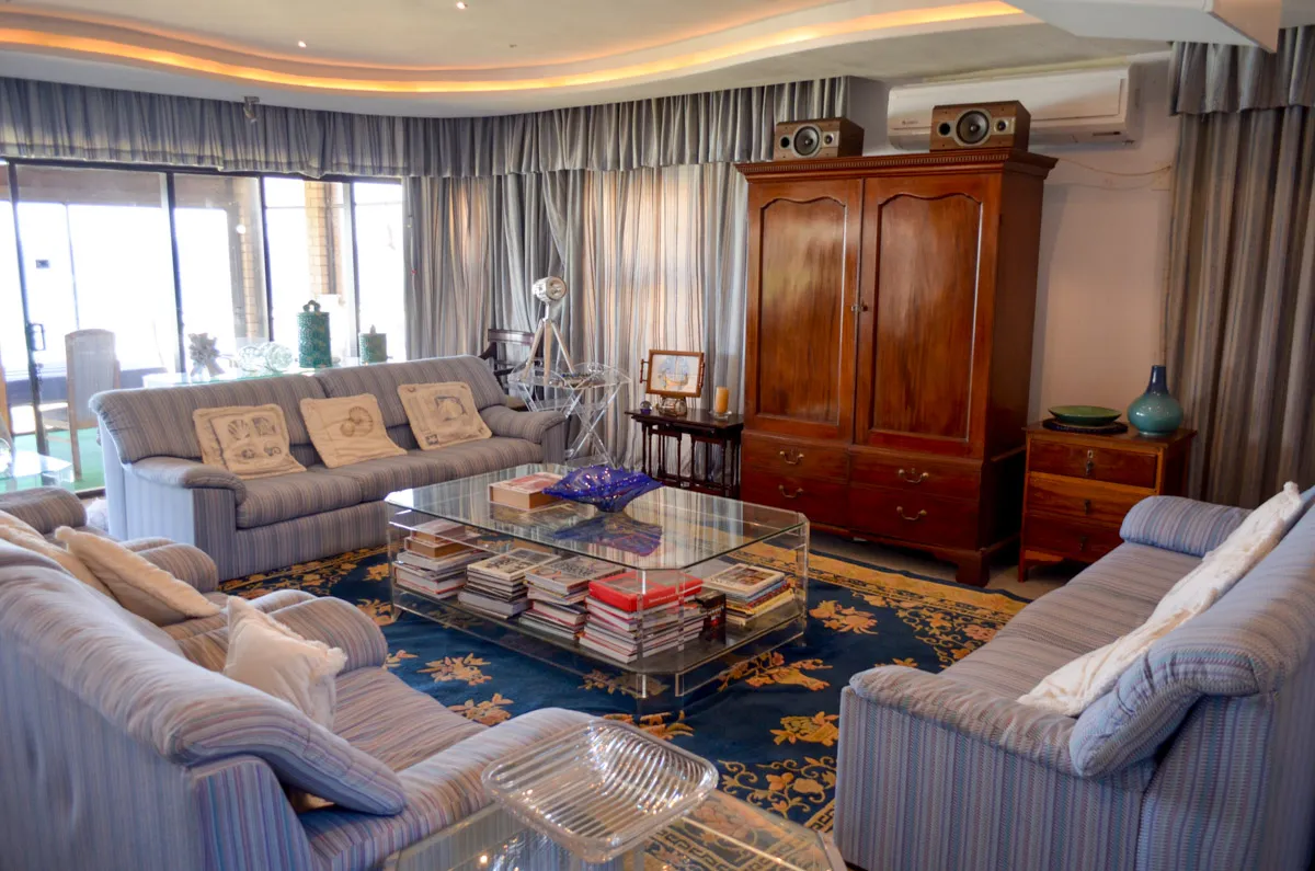 Cozy living room with sofas coffee table and wooden cabinet with speakers