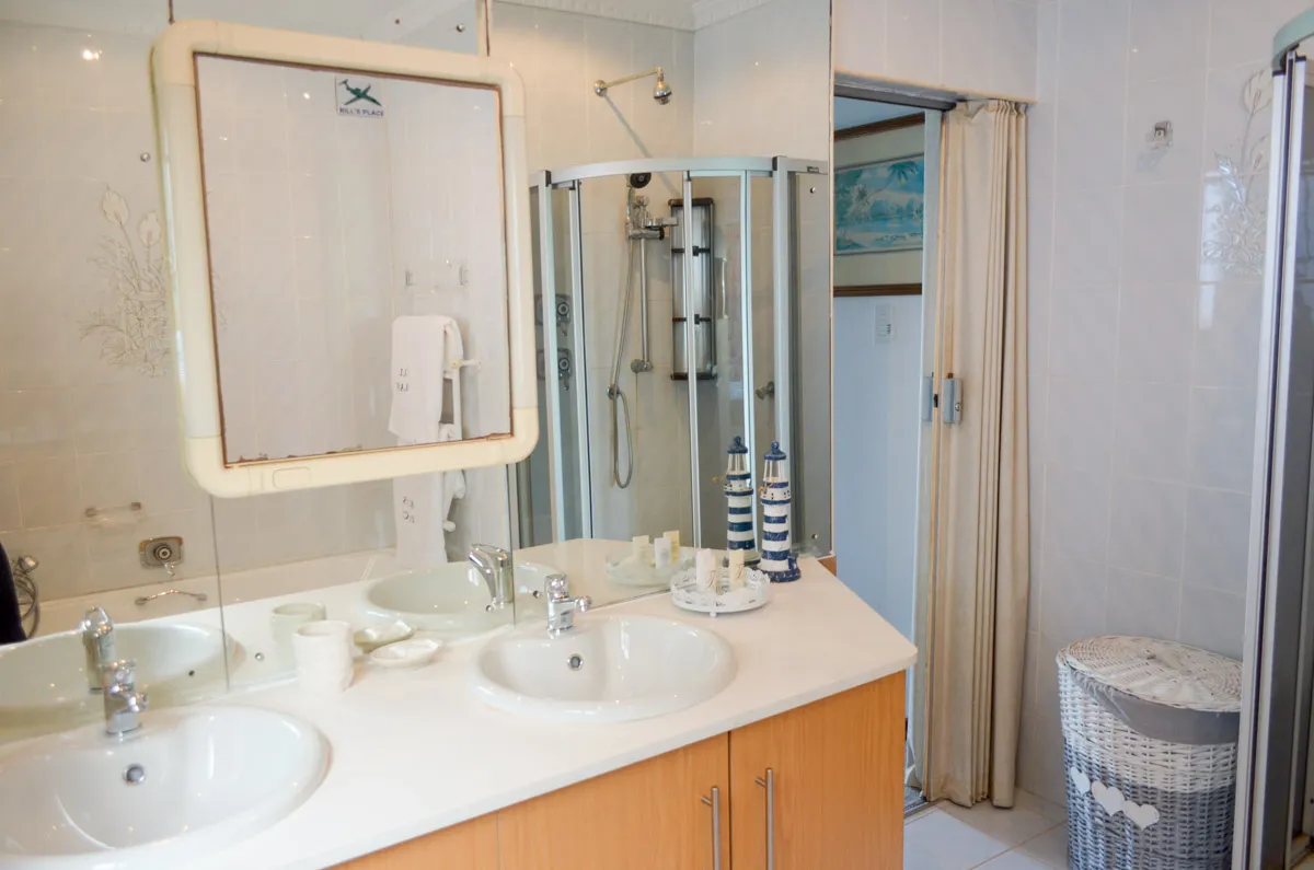 Modern bathroom with double sink mirror and shower