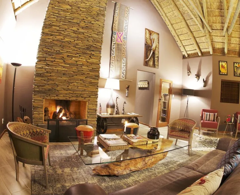 Cozy living room with stone fireplace wooden furniture and African decor