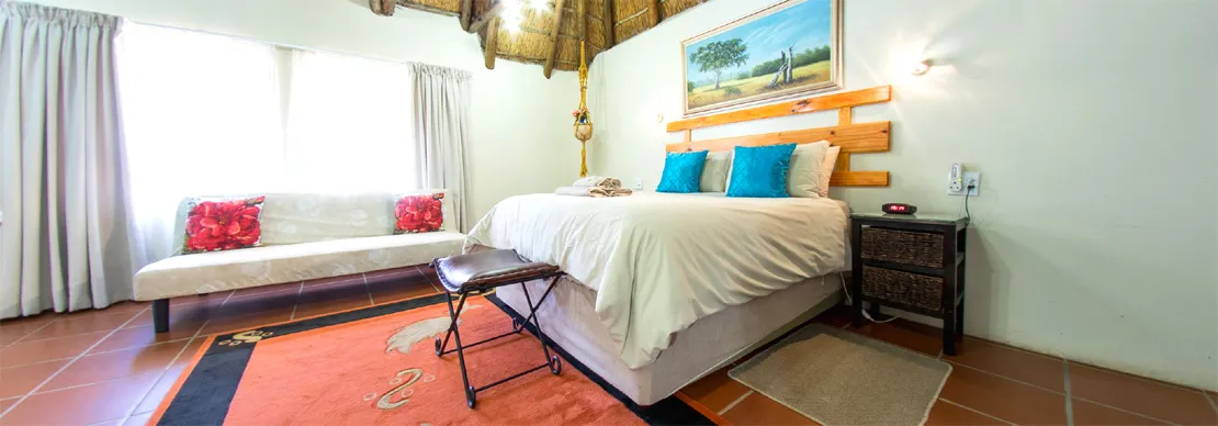 Cozy bedroom with a large bed sofa and wooden headboard