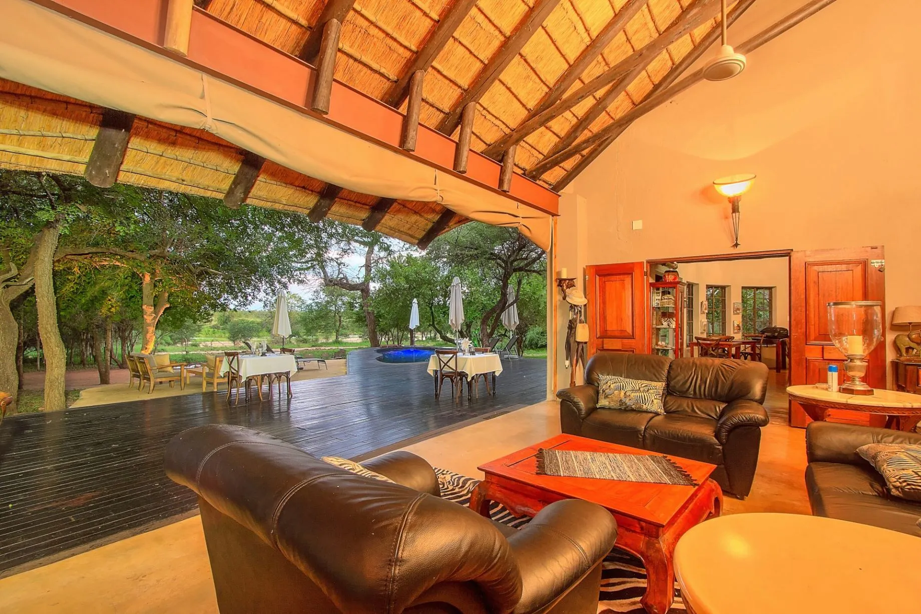 Cozy living room with outdoor view leather furniture and wooden ceiling