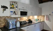 Modern kitchen with white cabinets black appliances and a fish decoration on the wall