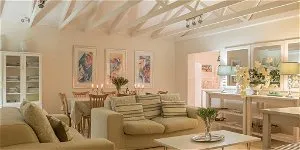 Cozy living room with sofas dining area and floral decorations in soft lighting