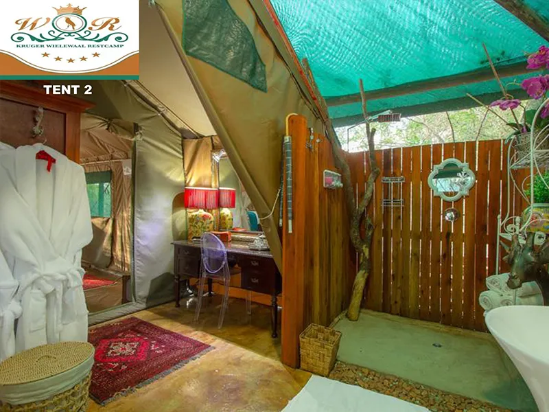 Luxury tent interior with wooden shower area and outdoor decor