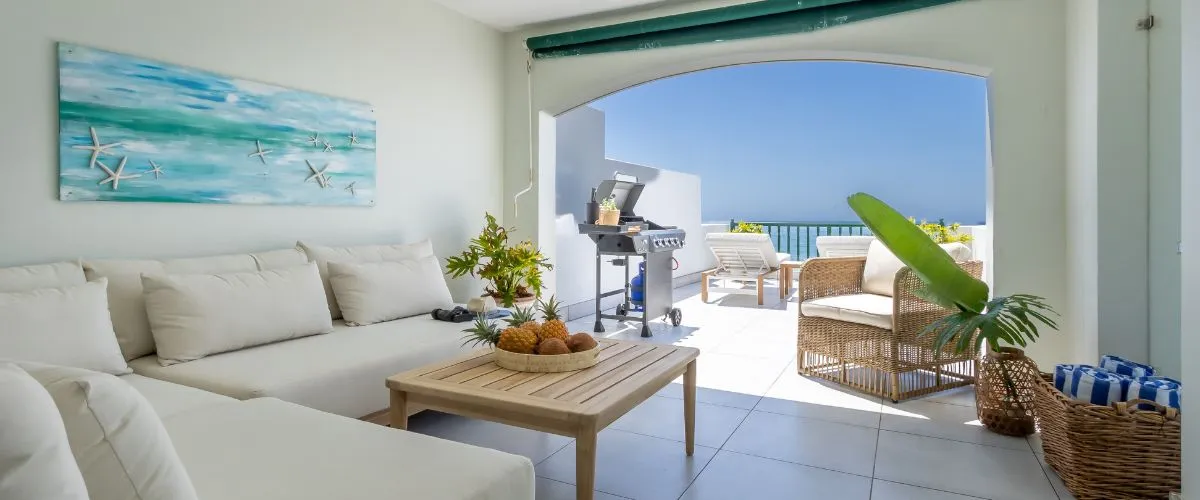 Modern living room with ocean view white furniture and potted plants
