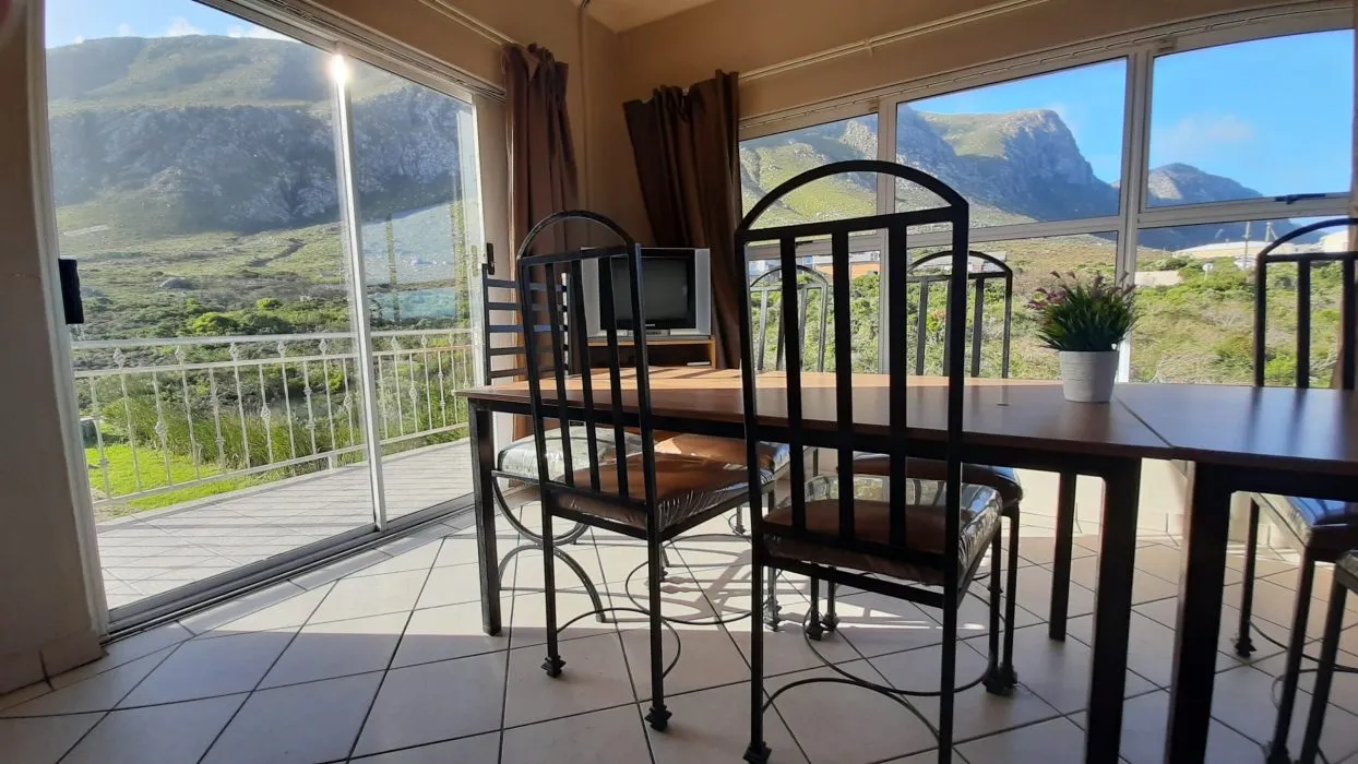 Dining area with mountain view through large windows and sliding glass door
