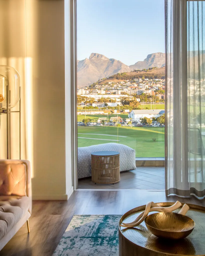 Modern living room with mountain view through large window and open door