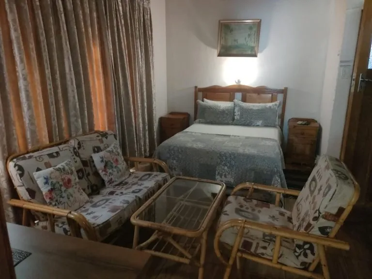 Cozy bedroom with floral furniture bed and bedside tables