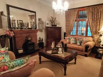 Cozy living room with fireplace wooden furniture and floral decor