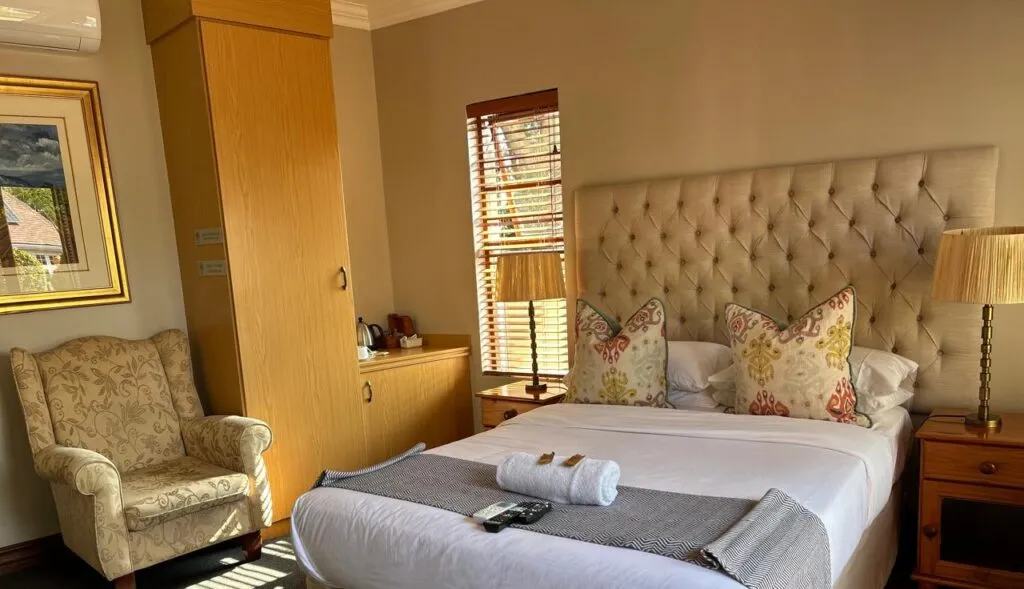 Cozy bedroom with a large bed armchair and wooden furniture