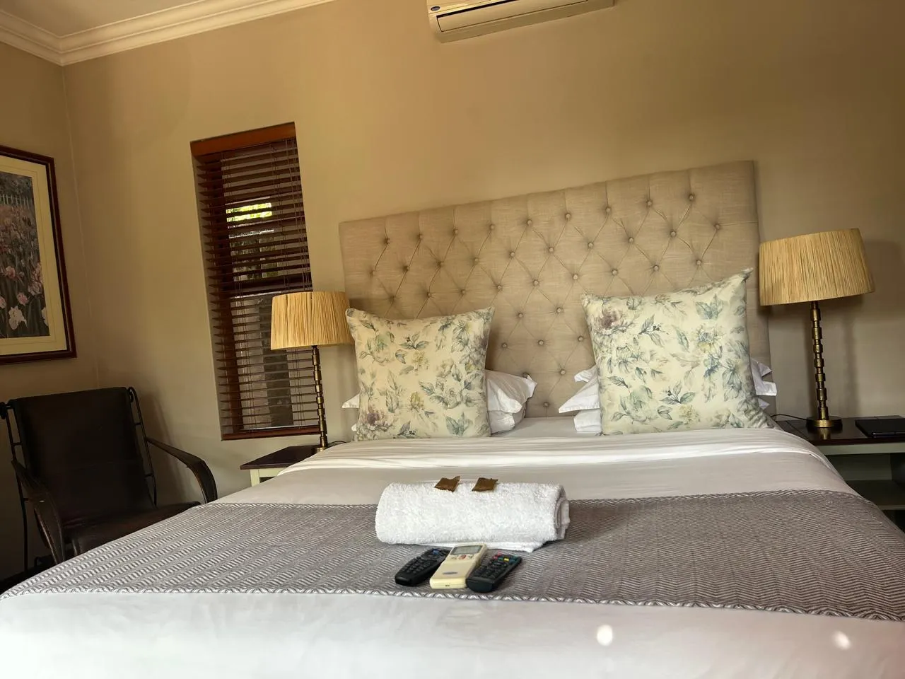 Cozy bedroom with a large bed floral pillows and bedside lamps