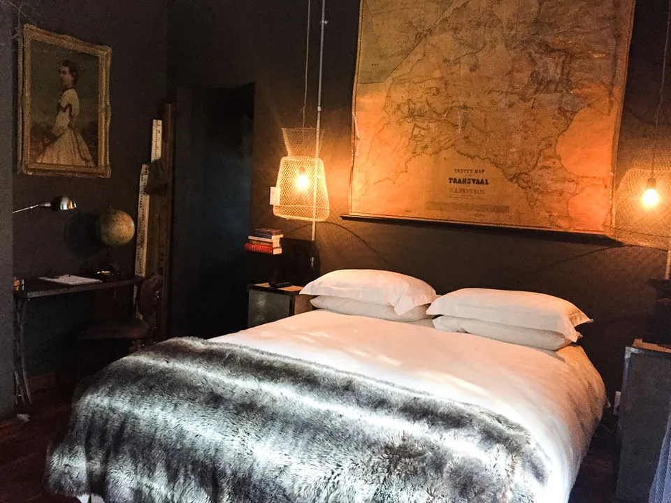 Cozy bedroom with a large bed map artwork and vintage decor