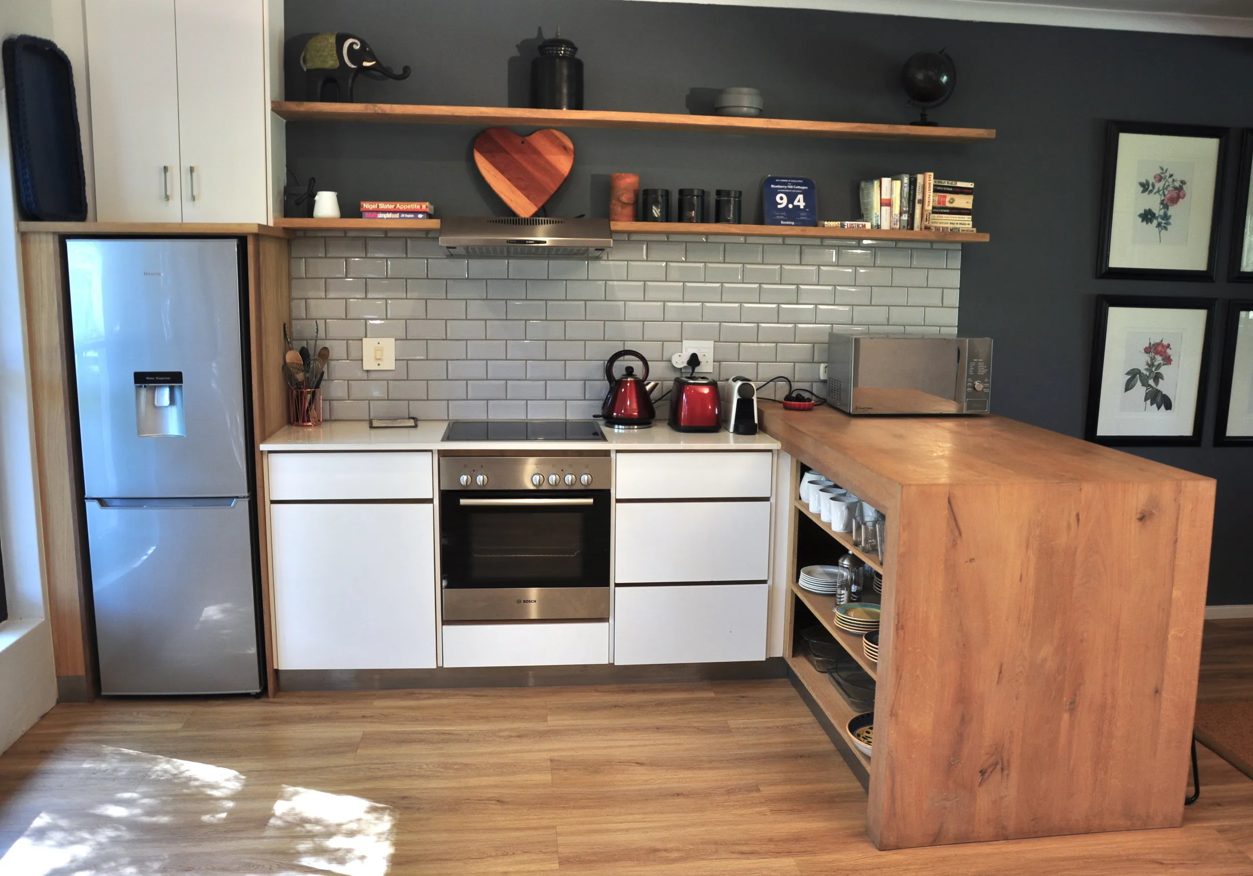 Modern kitchen with wooden island white cabinets and black walls