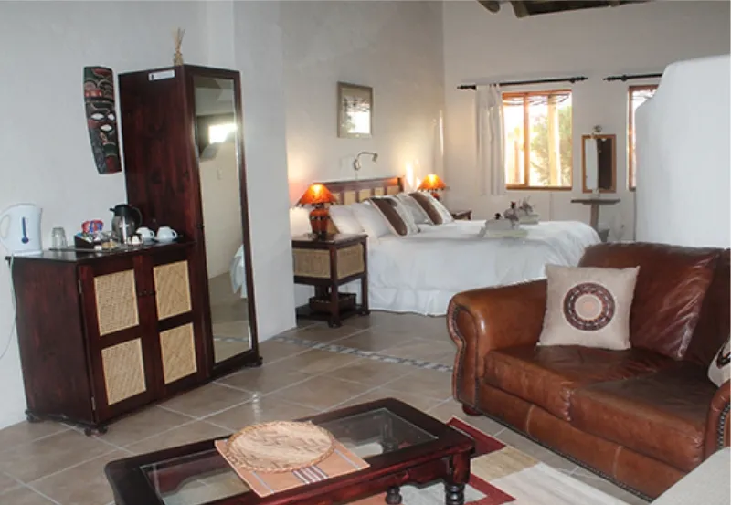 Cozy bedroom with a bed sofa coffee table and wooden furniture