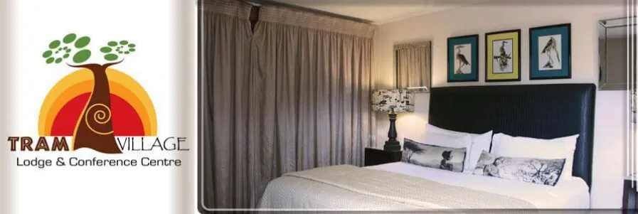 Logo and image of a neatly made bed in a hotel room with framed pictures