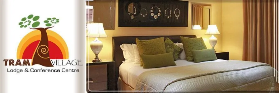 Logo of Tram Village Lodge  Conference Centre next to a cozy bedroom