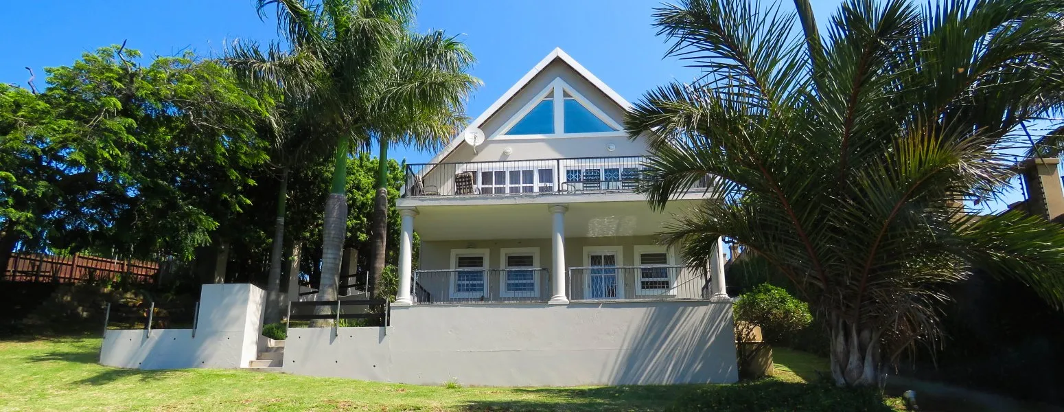 Modern twostory house with palm trees and garden in front