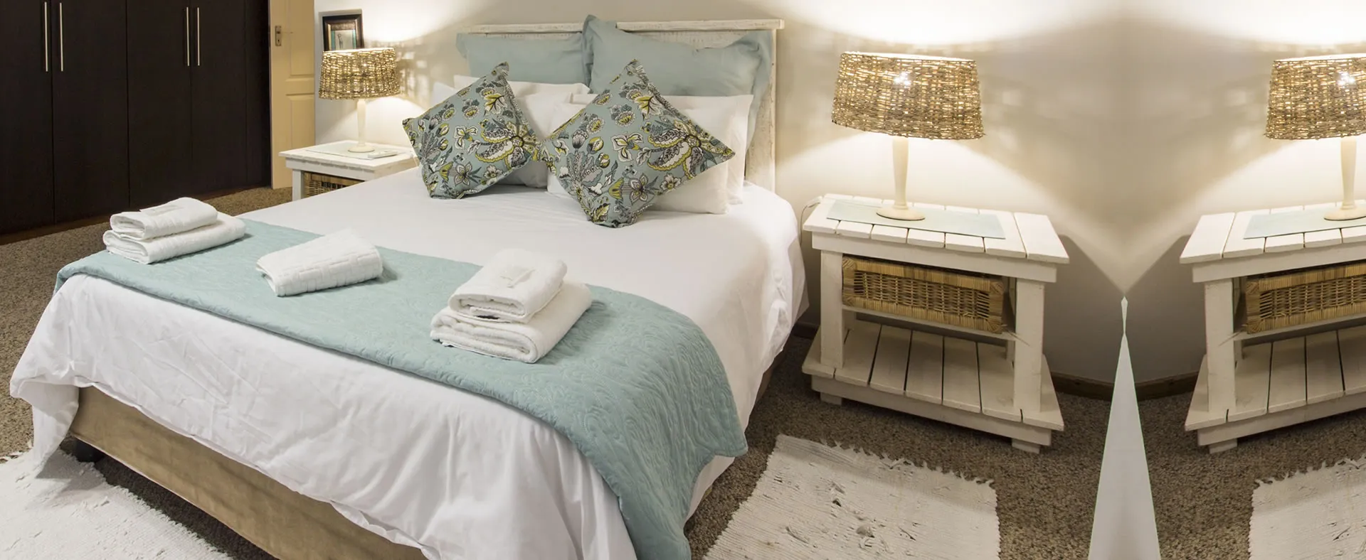 Cozy bedroom with a neatly made bed bedside tables and lamps