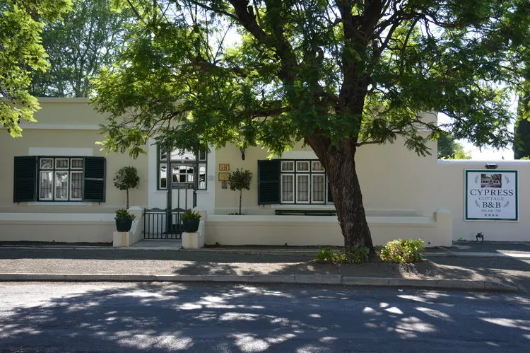 Singlestory building with a tree in front and a sign for Cypress BB