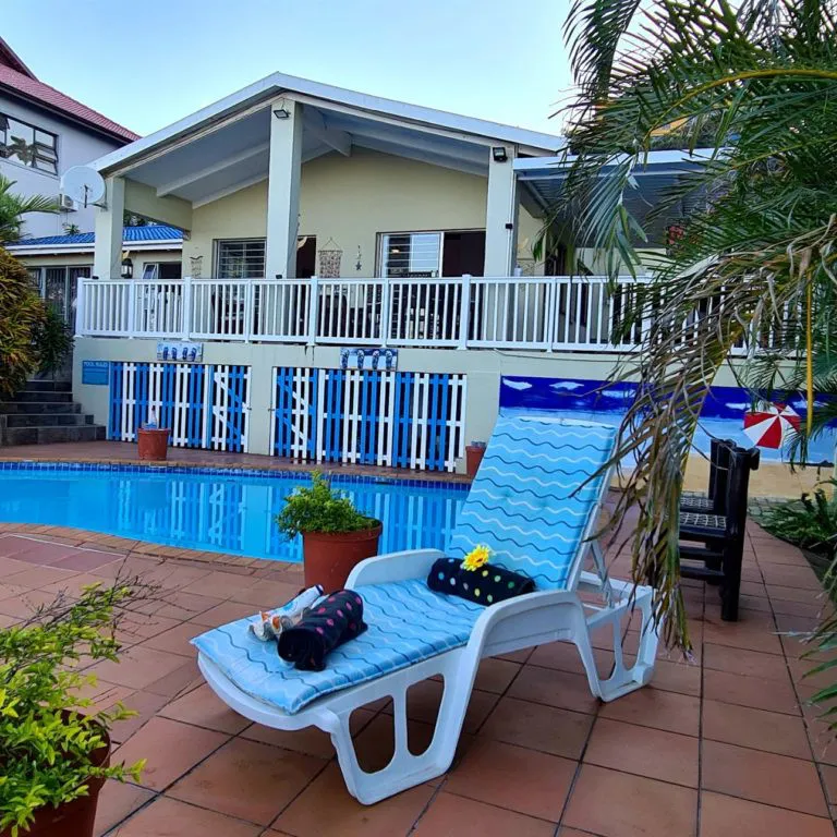 Swimming pool with lounge chair in a tropical garden setting