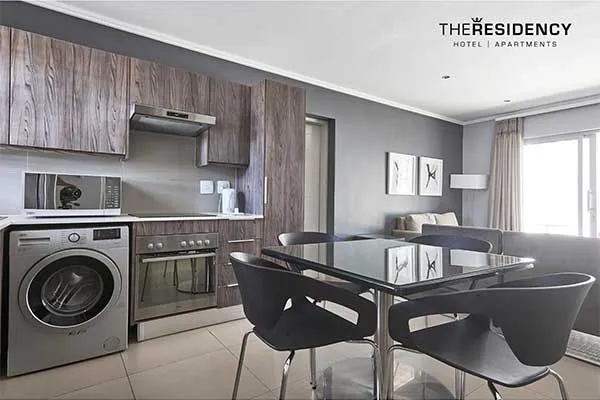 Modern kitchen and dining area in a hotel apartment with contemporary decor