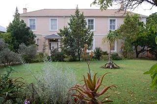 Twostory house with garden trees and shrubs in front