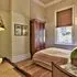 Cozy bedroom with wooden furniture bed and window with blinds
