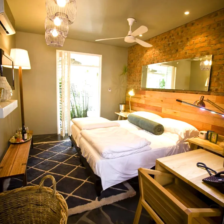 Cozy bedroom with a bed desk and brick wall decor