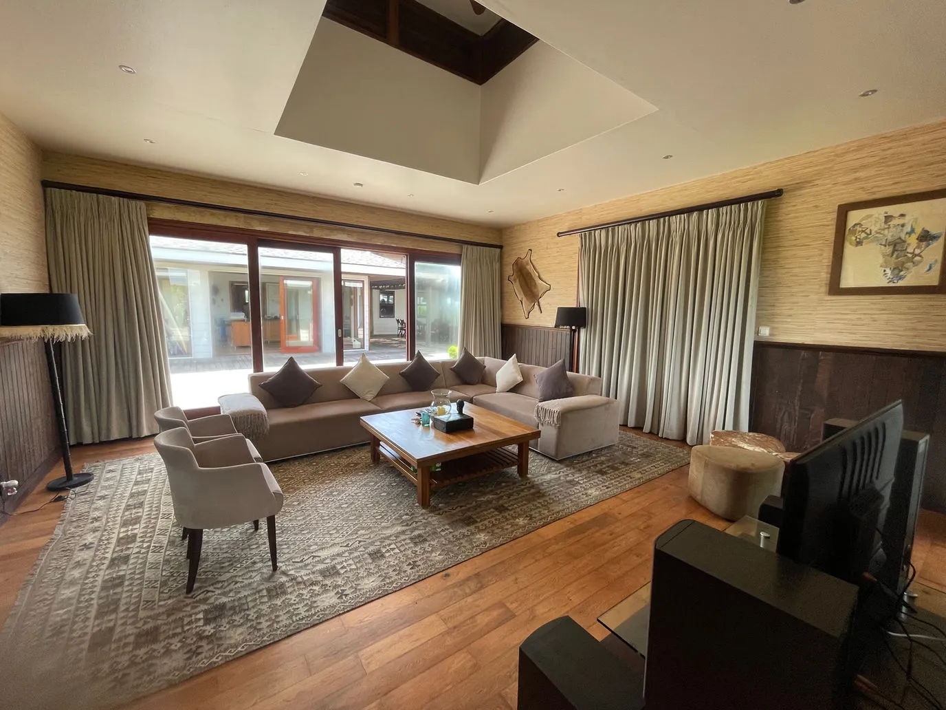 Modern living room with sofas coffee table and large windows with curtains