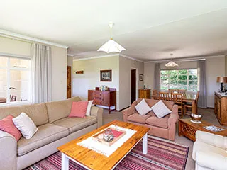 Cozy living room with sofas coffee table and dining area in background